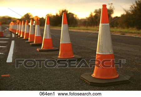 Stock Image - Row of Traffic Cones at Sunset UK. Fotosearch