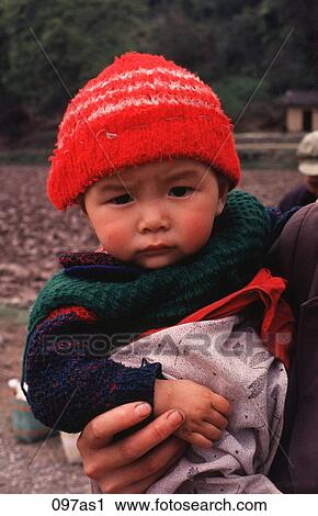 Stock Image - Baby Wearing a Red Hat. Fotosearch