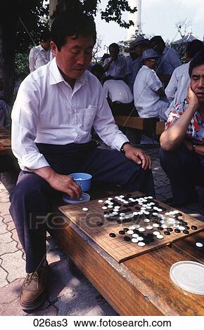 Stock Image - Man Playing Board Game Korea Asia. Fotosearch