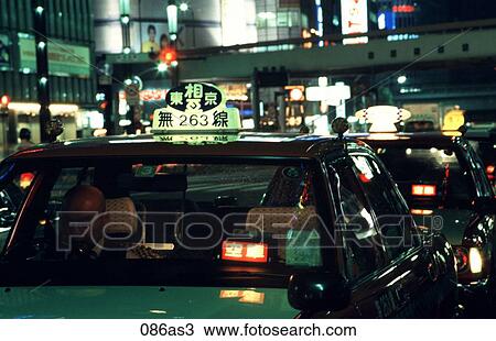 Stock Image - Taxi Waiting for Fare at Night Tokyo Japan Asia. Fotosearch