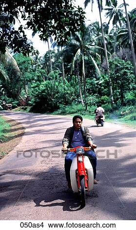 Picture - Man Riding Moped Basilan The Philippines Asia. Fotosearch