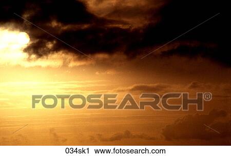 Stock Image - Orange Sky with Black Clouds. Fotosearch
