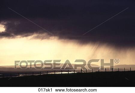 Stock Image - Rain Clouds over Headland. Fotosearch