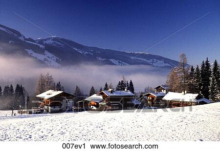 Stock Image - Snow Topped Wooden Houses Austria. Fotosearch