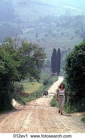 Woman Walking along a Country Lane Tuscany Italy View Large Photo Image Stock Image - Woman Walking along a Country Lane Tuscany Italy. Fotosearch