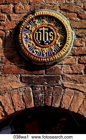 Stock Image - Colourful Plaque above Archway Italy. Fotosearch