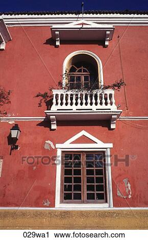 Stock Image - White Balcony in Red Wall Colombia. Fotosearch