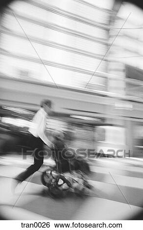 Stock Photograph - care giver, assistance, blur, black&white, assisting, disabled, airport. Fotosearch
