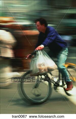 Stock Photo - bicycle, blur, blurred, deliveries, delivery. Fotosearch