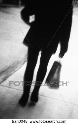 Stock Photo - black&white, blur, blurred, carrying, gifts, parcel, person. Fotosearch