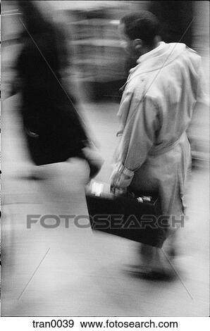 Stock Photo - briefcase, attache case, blurred, blur, black&white, businessman, African American. Fotosearch