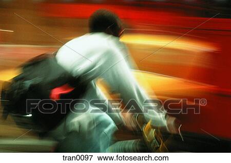 Stock Photo - bicycle, bike, blur, city, currier, hurrying. Fotosearch