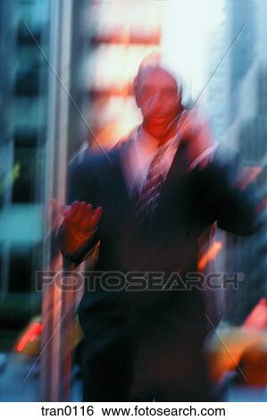 Stock Photograph - blurred, business, businessman, calling, cellphone, city, discussing. Fotosearch