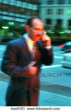 Stock Image - blurred businessman, blurred man, buildings, business, business suit, businessman, calling. Fotosearch