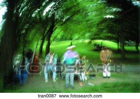 Stock Photo - grass, afternoon, ethnic, Central Park, band, green grass, Afracian Americans. Fotosearch