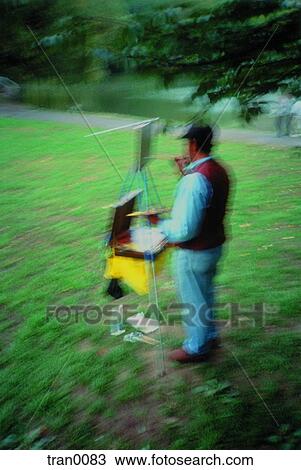 Stock Image - hobby, Central Park, hobbiest, green grass, easel, artist. Fotosearch