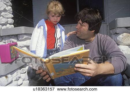A father reading with his daughter View Large Photo Image Stock Photo - A father reading with his daughter. Fotosearch