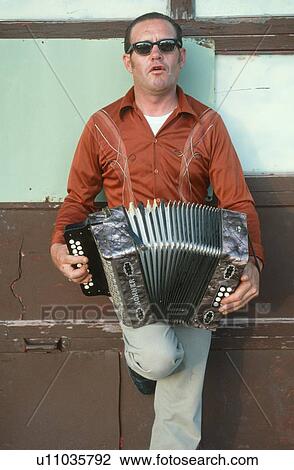 Stock Image - A man playing an accordion. Fotosearch