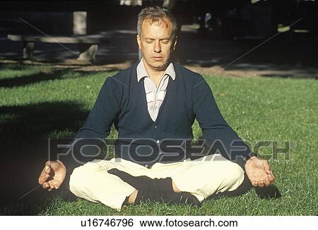 Stock Photograph - A meditator in sun light. Fotosearch