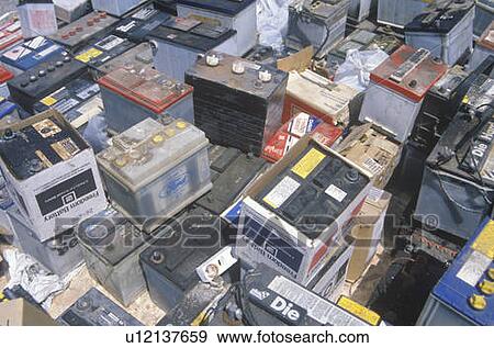Stock Photo - A pile of car batteries ready for disposal. Fotosearch