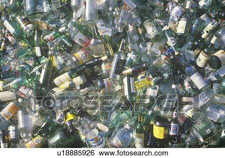Stock Photograph - A pile of glass beverage bottles waiting for recycling. Fotosearch