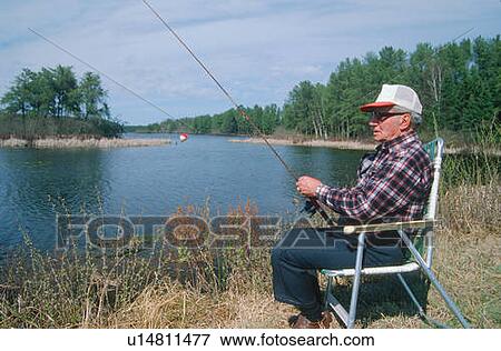 A retiree fishing on a lake View Large Photo Image Stock Photo - A retiree fishing on a lake. Fotosearch