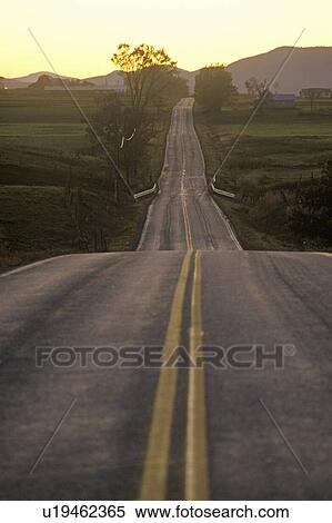 Stock Photography - A road that goes from Adirondack Vermont to New York during sunset. Fotosearch