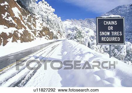 Stock Image - A sign that reads “Chains or Snow Tires Required”. Fotosearch