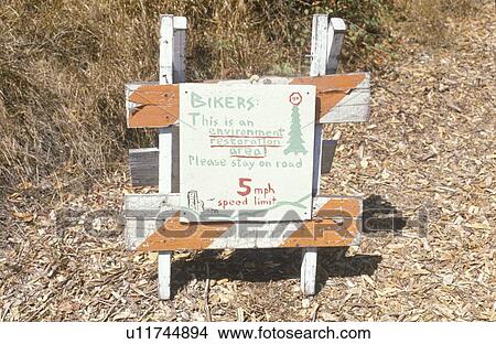 Picture - A sign warning bikers of an environmentally sensitive area is present. Fotosearch