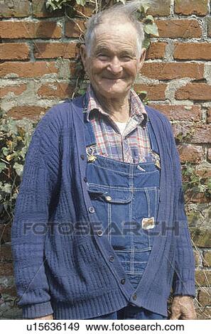 Stock Photo - A smiling senior citizen in overalls. Fotosearch