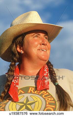 Stock Photograph - A woman wearing braids and straw hat. Fotosearch