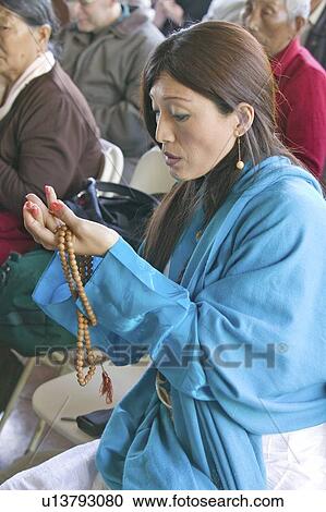 A woman's hands hold prayer beads and rice View Large Photo Image Stock Image - A woman's hands hold prayer beads and rice. Fotosearch