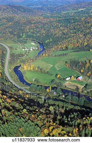 Stock Image - Aerial view of farm near Stowe, VT in autumn on Scenic Route 100. Fotosearch