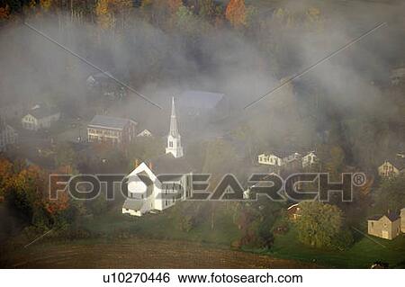 Stock Photograph - Aerial view of Stowe, VT in Autumn on Scenic Route 100, through fog. Fotosearch
