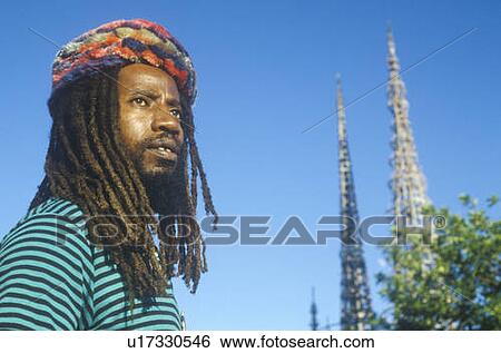 Stock Photograph - African American male poses with the Watts Towers. Fotosearch
