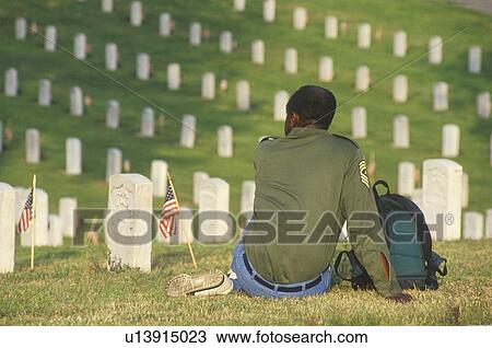 Stock Image - African-American Veteran Sitting in Cemetery, Los Angles, California. Fotosearch