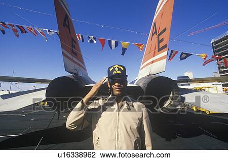 Stock Image - Afro-American Soldier Saluting By Aircraft, USS Forrestal. Fotosearch