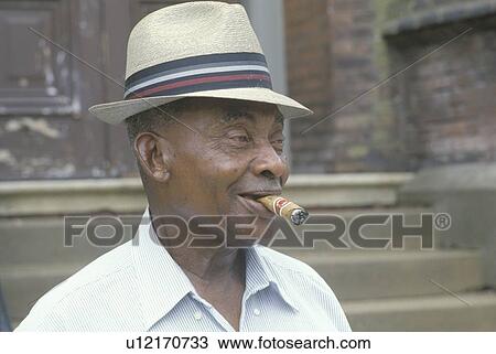 An African-American man smoking a cigar View Large Photo Image Stock Image - An African-American man smoking a cigar. Fotosearch