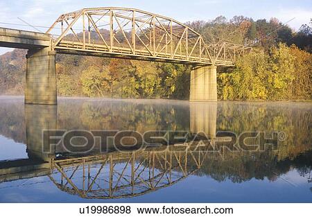 An arched bridge and autumn trees reflected in a river, Tennessee View Large Photo Image Stock Photo - An arched bridge and autumn trees reflected in a river, Tennessee. Fotosearch