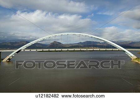 Stock Image - An arched bridge over Theodore Roosevelt Lake. Fotosearch