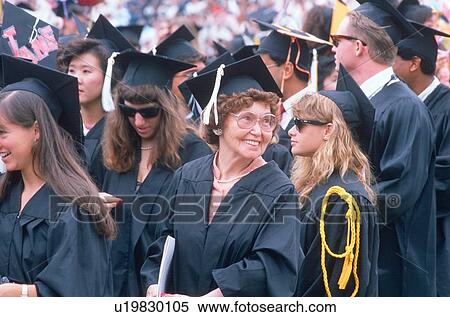 Stock Photography - An older graduate smiles at her ceremony. Fotosearch