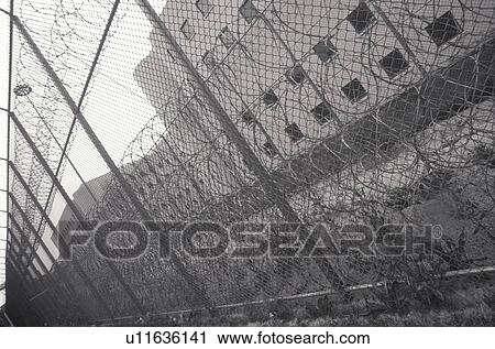 Stock Image - Barbed wire at prison. Fotosearch