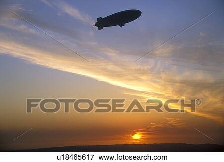 Stock Photo - Blimp silhouette against a Japanese sunset. Fotosearch