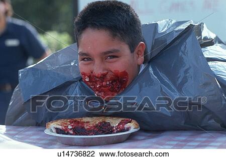 Stock Image - Boy at Pie Eating Contest. Fotosearch