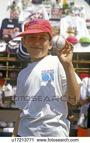 Stock Image - Boy Holding Autographed Baseball, Fenway Park, Boston, Massachusetts. Fotosearch