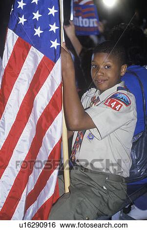 Boy Scout with an American flag View Large Photo Image Stock Photograph - Boy Scout with an American flag. Fotosearch
