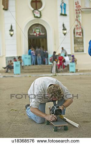 Stock Photograph - Cameraman on skateboard. Fotosearch