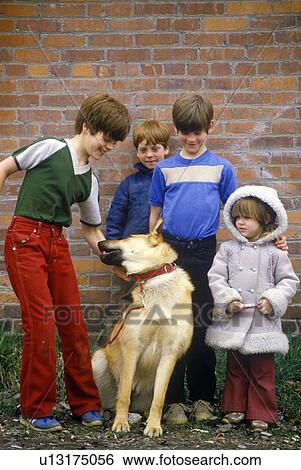 Stock Photograph - Children posing with dog. Fotosearch