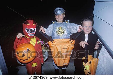 Stock Photo - Children trick or treating on Halloween. Fotosearch