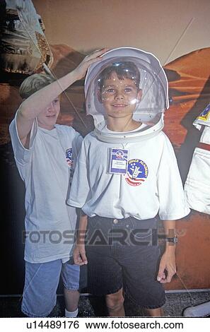 Stock Photograph - Children try on $1 million spacesuit at Space Camp. Fotosearch